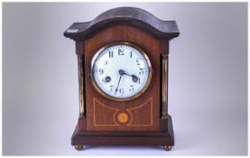 Edwardian Mahogany Inlaid Mantle Clock with a white enamel dial & brass pillar sides with shell