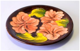 Moorcroft Cabinet Plate 'Coral Hibiscus' Pattern on chocolate ground. Moorcroft marks to base. 10.