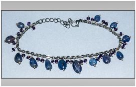 Tanzanite and Amethyst Charm Bracelet, polished ovoid tanzanites and small faceted amethysts