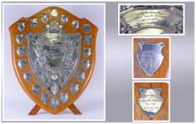 A Very Large Vintage Oak Shield Shaped Trophy Plaque with a central silver plated embossed plaque