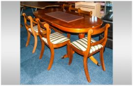 Yew Wood Dining Room Suite, with an extending table with a drop in leaf supported on a tripod leg