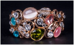 Crystal, 'Cat's Eye' and Gilt Openwork Cuff Bangle, a variety of stones in blue, green, peach and