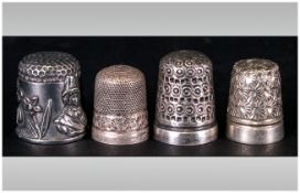 A Collection Of Antique Thimbles 4 in total. 2 with silver hallmarks.