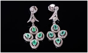 Colombian Emerald and Diamond Drop Earrings, each earring comprising four pear cut emeralds, mined