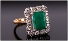 18ct Gold Emerald & Diamond Ring The central emerald surrounded by 16 diamonds. Marked 18ct.
