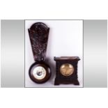 Carved Oak Aneroid Barometer. Together with a 1930's Bedroom Clock. With a round brass dial.