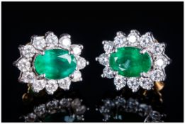 A Pair Of 18ct Gold Set Diamond & Emerald Cluster Earrings The central oval cut Emerald surrounded