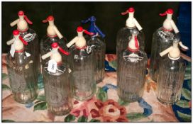 Eleven Acid Etched Vintage Soda Bottles for Cambrian Soda Water, with Original Plastic Tops.