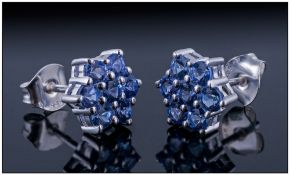 Tanzanite Cluster Earrings, each a cluster of seven round cut tanzanites in a flower or star