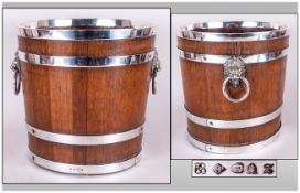 Edwardian Oak Wine Cooler with plated bands around the body, lion mask ring handles. With