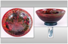 William Moorcroft Signed Flambe Footed Bowl 'Clematis' Pattern on a brandy effects colourway ground.