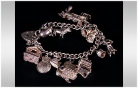 A Silver Charm Bracelet Loaded with 11 charms, Fully hallmarked. 56.6grams.