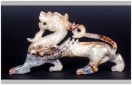 Chinese Jadeite Pebble Carving Of A Dragon, Rearing Prancing Forward With Tail Up Turned and Head