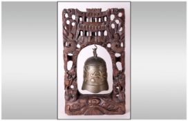 Chinese Bronze Alter Bell Cast with cast with a bird design, Handing in a carvel teakwood.