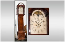 8 Day Oak Cased Grandfather Clock with an arched top rolling moon enameled dial, the hood with a