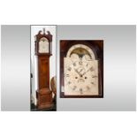 8 Day Oak Cased Grandfather Clock with an arched top rolling moon enameled dial, the hood with a