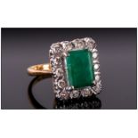 18ct Gold Emerald & Diamond Ring The central emerald surrounded by 16 diamonds. Marked 18ct.