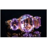 Kunzite Pink Quartz Three Stone Ring, the oval cut centre stone being 5cts, with a further oval