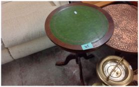 Round Wooden Table with Green on Top.