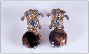 Tiffany Stone and Tanzanite Pair of Drop Earrings, a round cut cabochon of the rare, opaque gem,