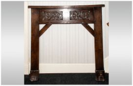 Arts and Crafts Carved Oak Cotswold School Fire Surround with floral carved decoration.