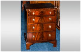 Reproduction Mahogany George I Style Bachelor Chest with flap top, on four graduated drawers, on