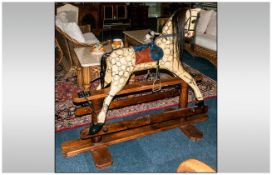 An Early 20thC Rocking Horse of Large Size, decorated in dappled cream colour with a leatherette