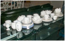 Quantity of White Shelley, some with blue painted rim. (60) pieces approximately. Comprises cups,