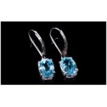 Sky Blue Topaz Pair of Drop Earrings, each one comprising a 2.25ct oval cut, bright, sky blue topaz,