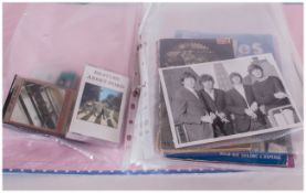 Folder of Assorted Beatles and Pop Memorabilia including cassettes, Record Song Books, postcards,