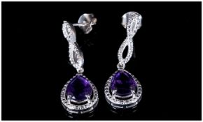 Amethyst Infinity Loop Drop Earrings, each earring having a pear cut, 1.25ct purple amethyst of good
