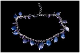 Tanzanite and Amethyst Charm Bracelet, polished ovoid tanzanites and small faceted amethysts