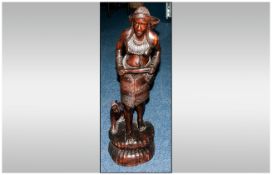 Carved African Figure of a Native Woman. With her dog and carrying a basket. 35 inches high.