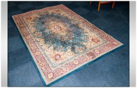 Large Rug predominantly blue, beige and red in colour. Made in Belguim. 112 by 76 inches.