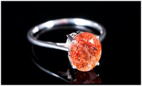 Tanzanian Sunstone Solitaire Ring, an oval cut of the peach and burnt orange feldspar, mined in