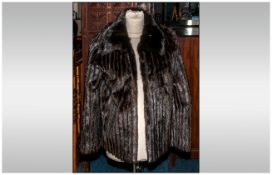 Ladies Dark Brown Mink Tail Jacket. Strips of mink tail between strips of black suede. Fully lined