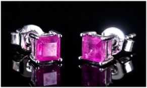 Ruby Pair of Stud Earrings, square cut rubies of 1.25cts set in rhodium vermeil and silver, with