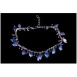 Tanzanite and Amethyst Charm Bracelet, polished ovoid tanzanites and small faceted amethysts