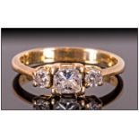 18ct Gold Diamond Ring Set With A Central Square Cut Diamond Between Two Round Brilliant Cut