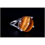 Tiger Eye Solitaire Ring, a 9.75ct round cut cabochon tiger eye, with a good display of the golden