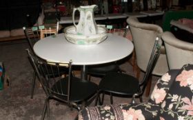 White Dining Table & Metal Legs and 4 Metal Chairs with Black Cushions.