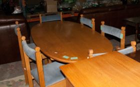 Wooden Oval Dining Table, with 6 Chairs, Blue Cushion Seats & Back Rests.