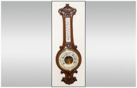 A Carved and Polished Oak Banjo Shaped Aneroid Barometer with Porcelain Dial and Thermometer. c.