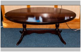 An Oval Mahogany Inlaid Sheraton  Style Low Coffee Table. On turned column supports, terminating