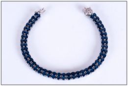Blue Sapphire and Diamond Bracelet, a double row of rich blue, oval cut sapphires, totalling a