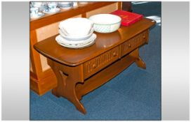 Ercol Golden Dawn Colour Coffee Table in the Jacobean style with two carved front doors. Supported