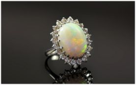 18ct White Gold Opal and Diamond Cluster Ring. The Large Opal Surrounded by 20 Small Diamonds,