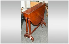 Victorian Oval Mahogany Flap Sided Sutherland Table supported by Baluster shaped side legs, on