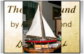 Mid 20thC Scratch Built Model of a Sailing Yacht with stand. Height 36 inches. Length 25 inches.