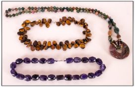 Three Various Gemstone Necklaces Comprising faceted amethyst, long Indian agate with 'doughnut'